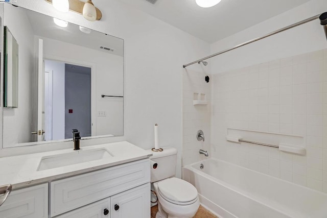 full bathroom featuring tiled shower / bath, vanity, and toilet