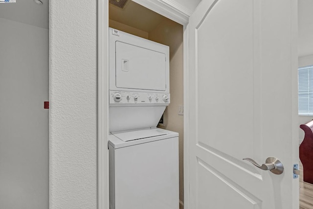 laundry room featuring stacked washer and clothes dryer