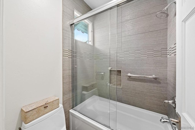 bathroom with enclosed tub / shower combo and toilet