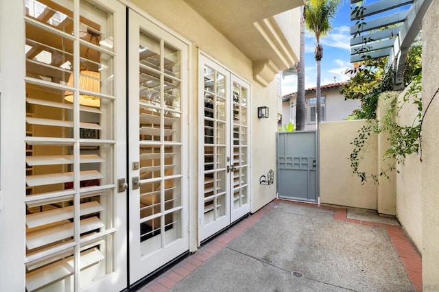 balcony featuring a pergola and french doors