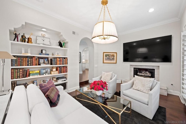 living room featuring dark hardwood / wood-style flooring and crown molding