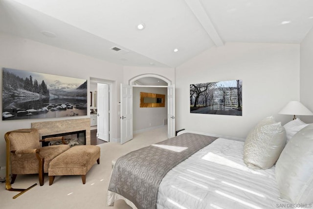 bedroom featuring light carpet and vaulted ceiling with beams