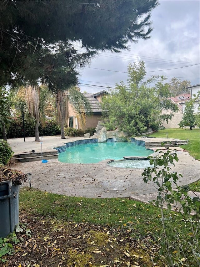 view of swimming pool with a patio area and an in ground hot tub