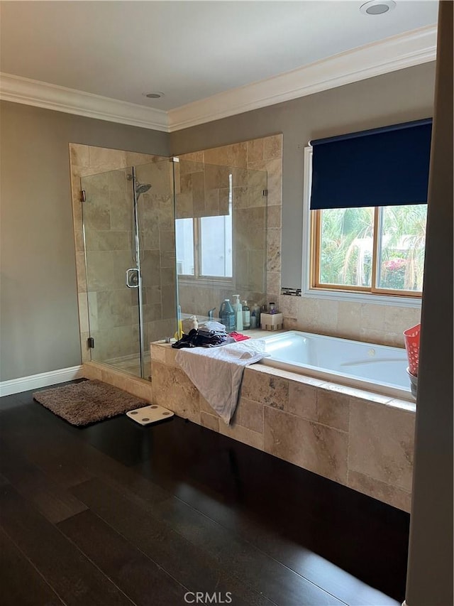 bathroom with ornamental molding, independent shower and bath, and hardwood / wood-style floors