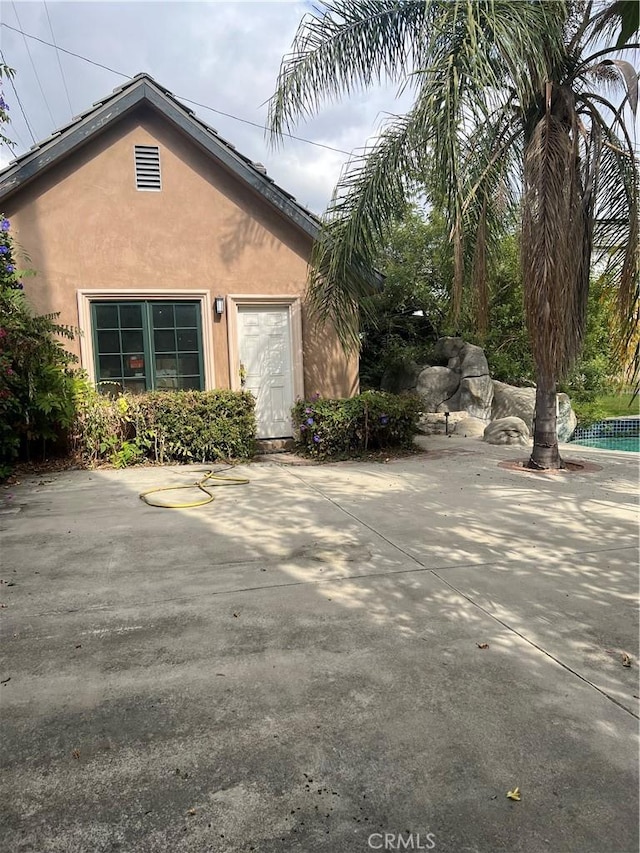 view of property exterior featuring a patio