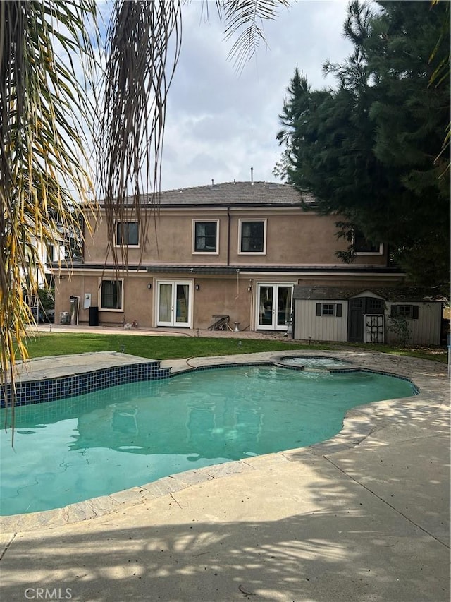 view of swimming pool featuring an in ground hot tub and a patio area