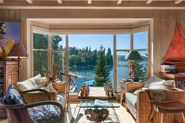 sunroom with a water view and beam ceiling