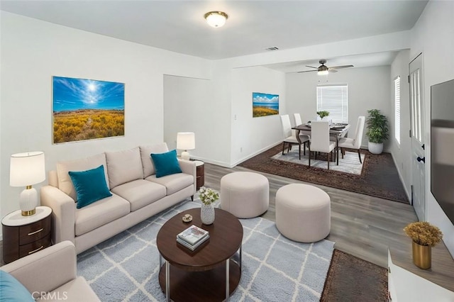 living room with hardwood / wood-style flooring and ceiling fan