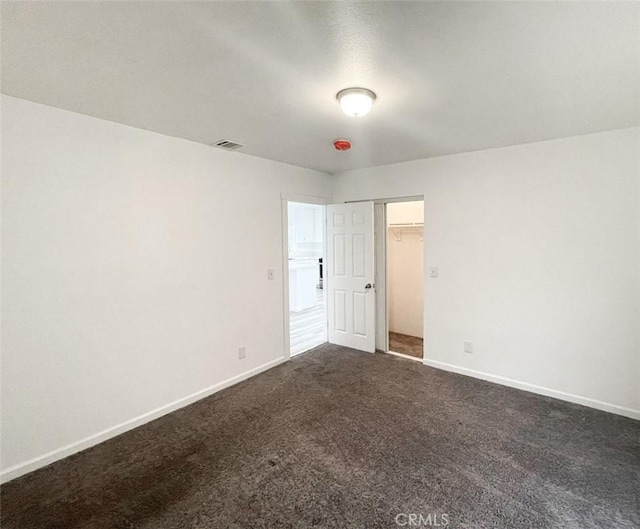 empty room with dark carpet