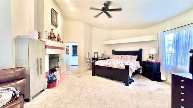 carpeted bedroom with ceiling fan and vaulted ceiling