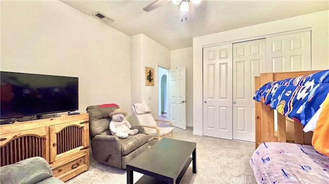 carpeted living room featuring ceiling fan