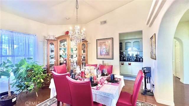 dining room featuring an inviting chandelier and lofted ceiling