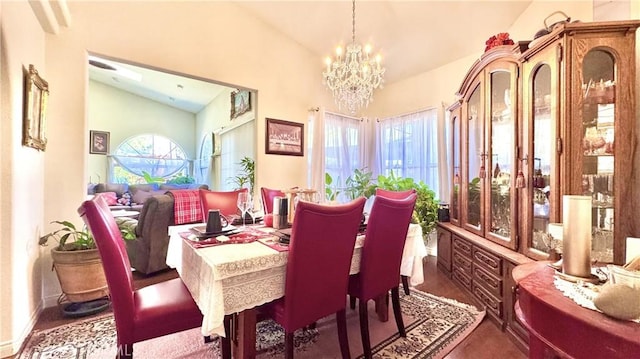 dining space featuring vaulted ceiling and a notable chandelier