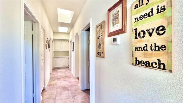 hall featuring light tile patterned flooring