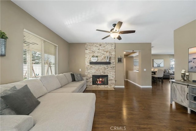 living room with ceiling fan, a fireplace, a healthy amount of sunlight, and dark hardwood / wood-style flooring