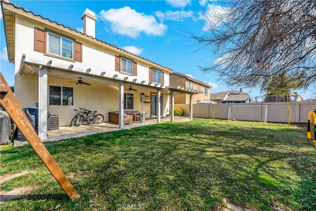 rear view of house featuring a lawn, a patio, and ceiling fan