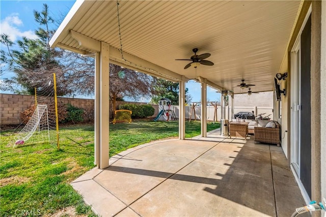 view of patio featuring ceiling fan, an outdoor living space, and a playground