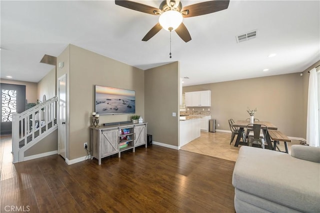 living room with hardwood / wood-style flooring and ceiling fan