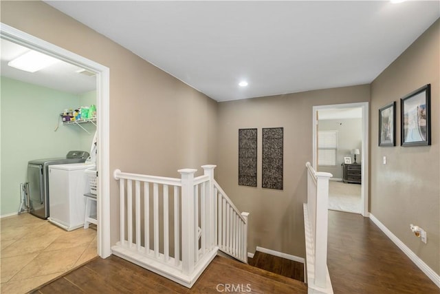 corridor featuring washing machine and dryer and hardwood / wood-style floors