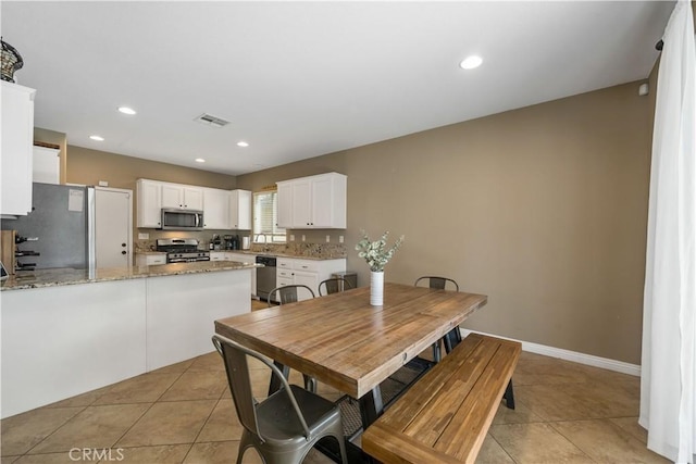 dining area with sink and light tile patterned floors