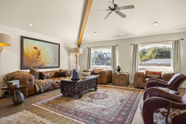 living room with wood-type flooring, lofted ceiling with beams, and ceiling fan