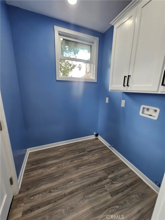 laundry room featuring hookup for a washing machine, dark hardwood / wood-style flooring, and cabinets