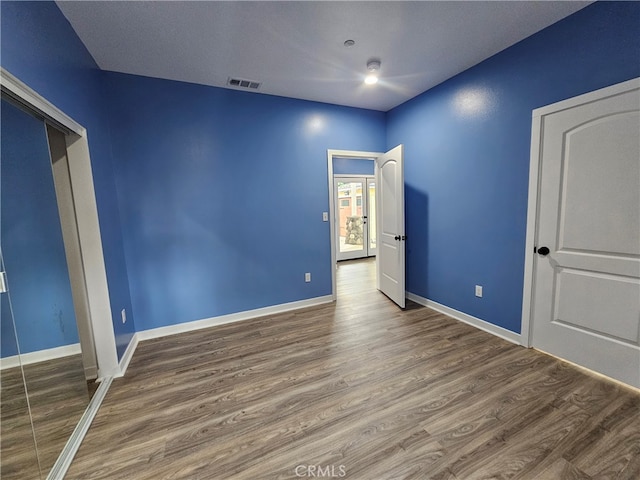 empty room with dark wood-type flooring