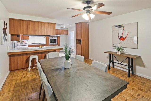 dining space featuring parquet floors and ceiling fan