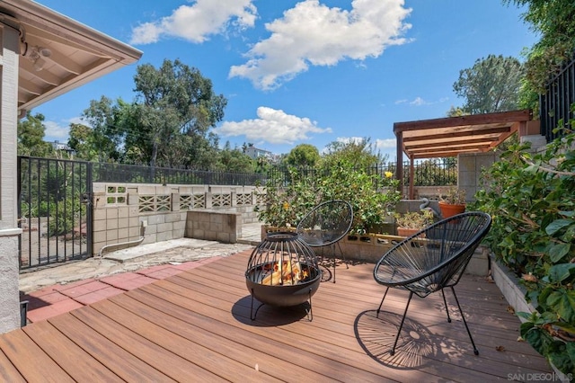 wooden terrace with a fire pit