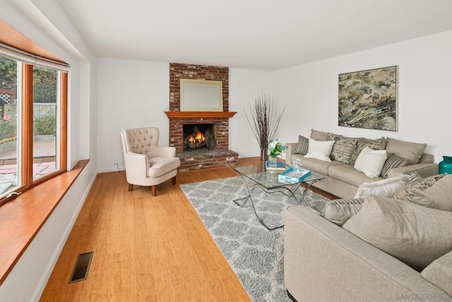 living room with wood-type flooring and a fireplace