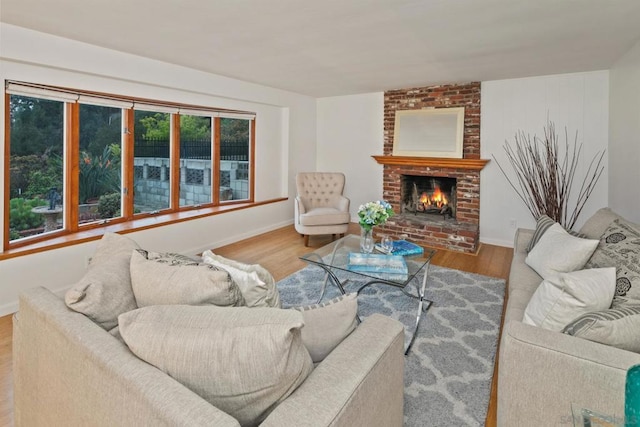 living room with a fireplace and light wood-type flooring