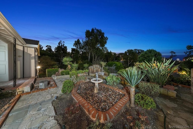 view of patio terrace at dusk