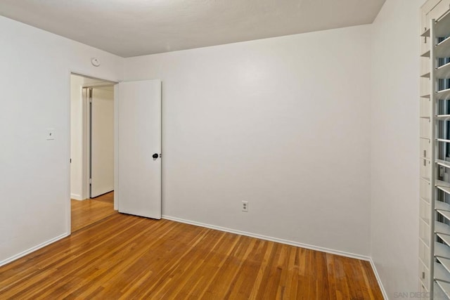 spare room with wood-type flooring