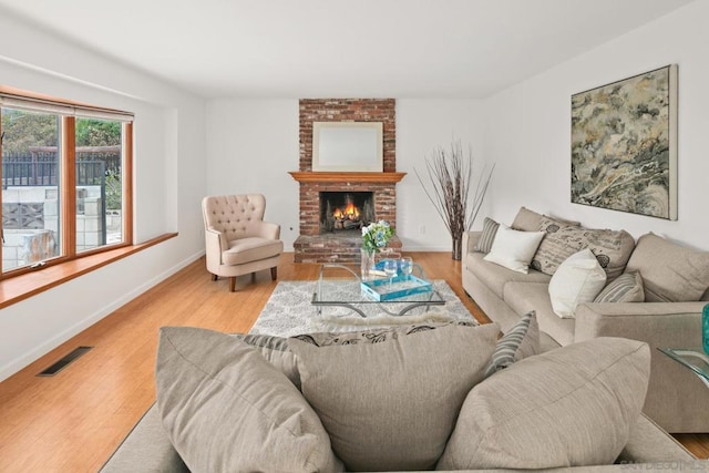 living room featuring a fireplace and light wood-type flooring