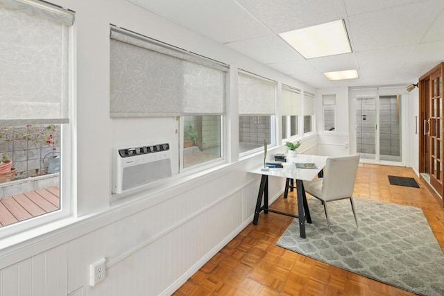 office featuring a drop ceiling, cooling unit, and parquet flooring