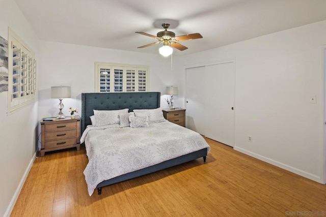 bedroom with a closet, ceiling fan, and light hardwood / wood-style flooring