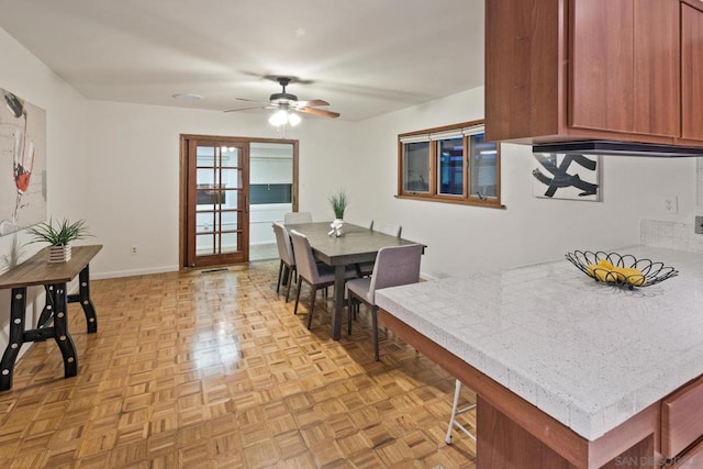 dining area featuring light parquet flooring and ceiling fan