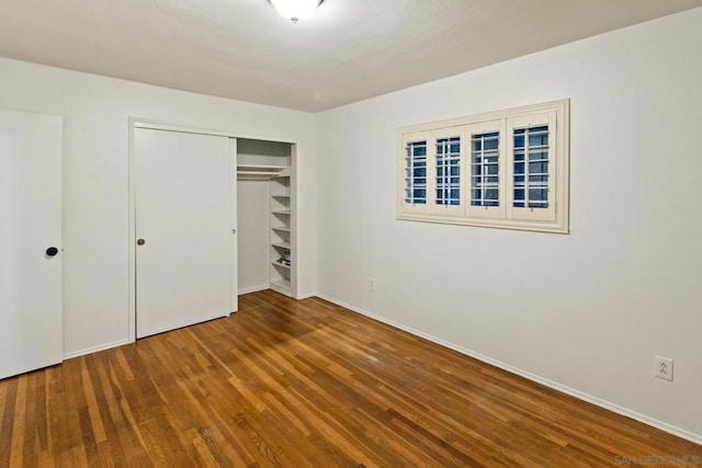 unfurnished bedroom featuring hardwood / wood-style flooring and a closet