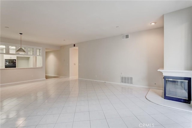 unfurnished living room featuring light tile patterned floors