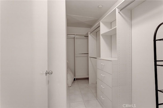 spacious closet with light tile patterned floors