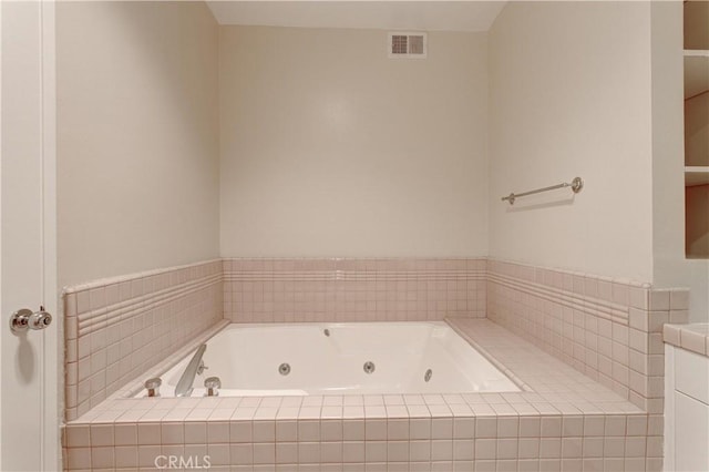 bathroom with tiled tub