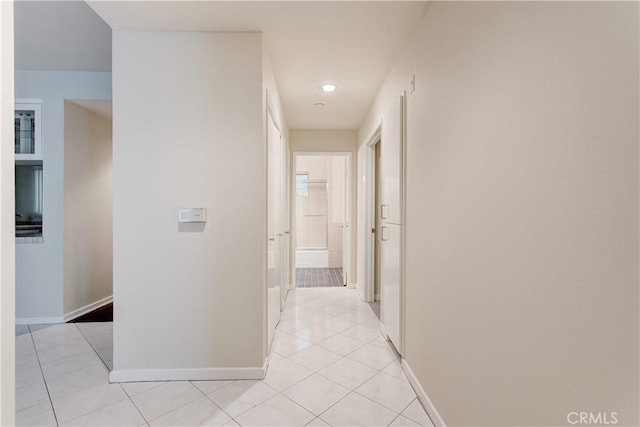 corridor featuring light tile patterned flooring