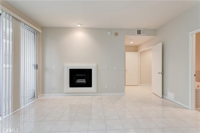 unfurnished living room with plenty of natural light and light tile patterned floors