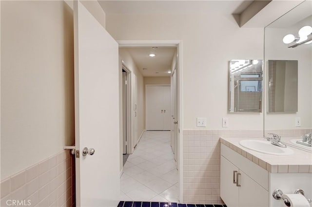 bathroom featuring tile walls, vanity, and tile patterned flooring