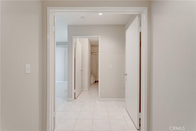 hall featuring light tile patterned floors