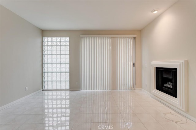 unfurnished living room with light tile patterned flooring