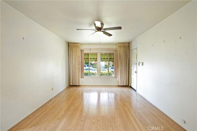 unfurnished room with ceiling fan and light wood-type flooring