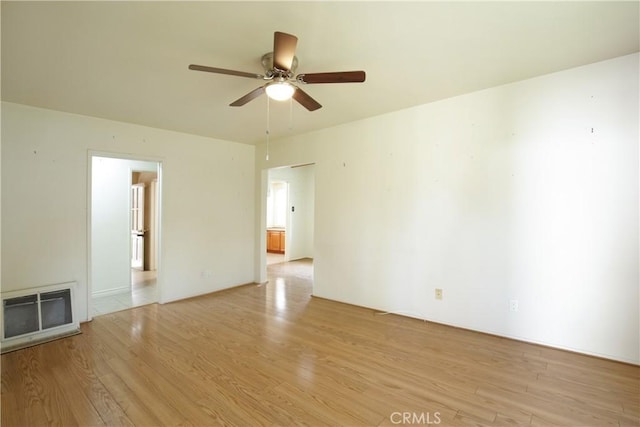 unfurnished room with ceiling fan and light wood-type flooring