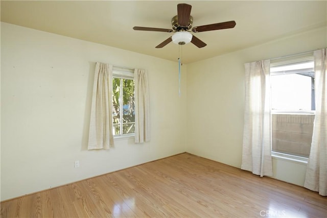 unfurnished room with ceiling fan and light wood-type flooring