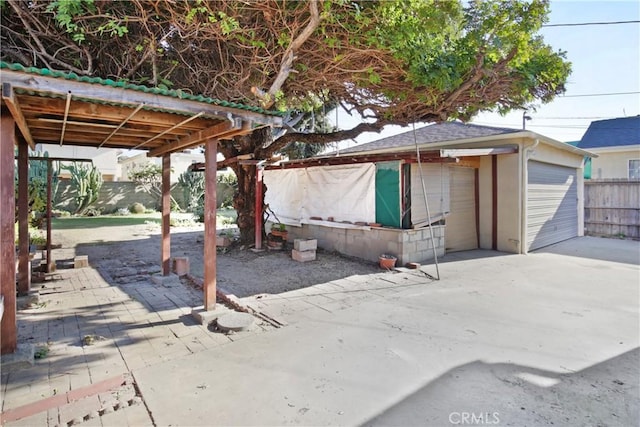 view of patio with an outbuilding and a garage